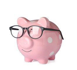 Piggy bank with glasses isolated on white