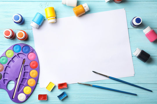 Flat Lay Composition With Empty Paper And Painting Supplies For Child On Table. Space For Text