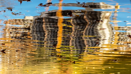 reflection in the water of a building under construction