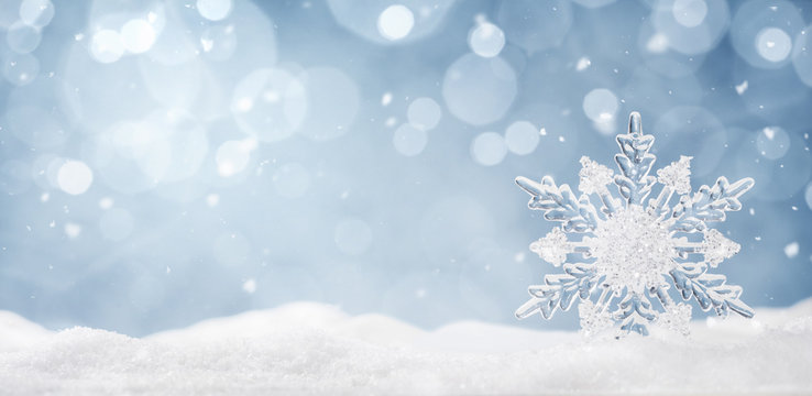 Winter background, ice crystal snowflake in the snow with copy space 