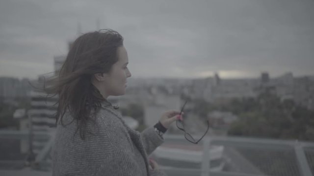 Beautiful girl turns to the camera and smiles. Slow motion, s-log.