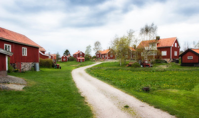 Fototapeta na wymiar red swedish houses in Harstena, a little fishing village in the Gry skerry garden, swedish east coast