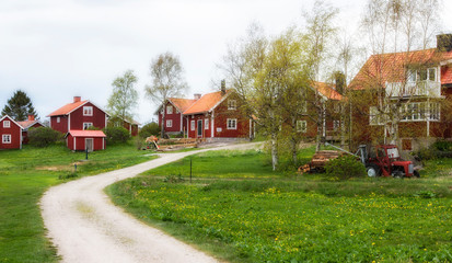 Obraz premium red swedish houses in Harstena, a little fishing village in the Gry skerry garden, swedish east coast