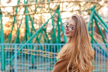 beautiful girl on a city street in the evening in the autumn