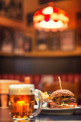 american hamburger with glass of beer of wine in american restaurant, product photography for restaurant in american style