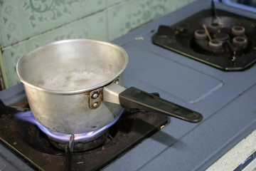 Boiling water in pan in kitchen