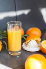 Oranges and juicer for making orange juice.. Black-gray background.