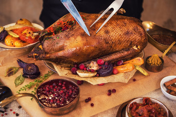 Roasted stuffed goose with herbs berries and vegetables. Ready to Christmas time. © olinchuk