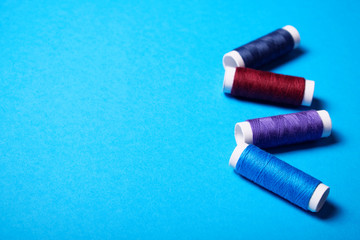 Red and blue sewing threads.