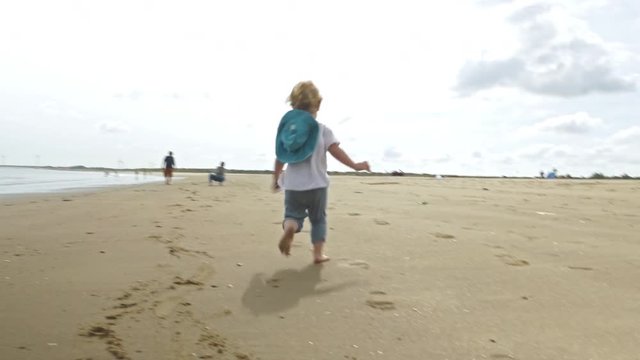 Toddler Running on Beach