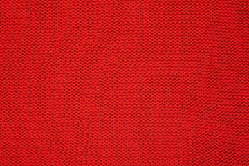 Red knitted texture. Handmade Knitwear. Background