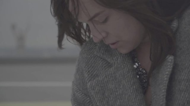 Cute girl in windy weather outdoors. Slow motion, s-log, ungraded