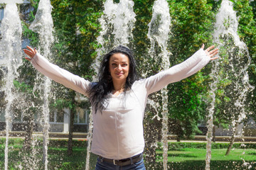 Brunette woman on fountain background