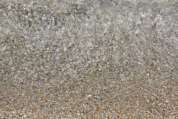 Shallow sea water beach pebbles reflection