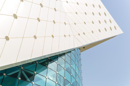 Modern white building with glass front against a blue sky