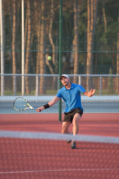 Male tennis player hitting the ball with forehand stroke technique