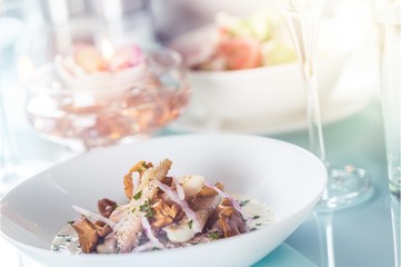 Close-up of Table with Food, Plates, Candles and Champagne