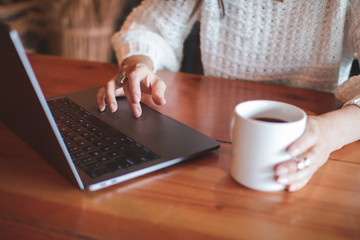 Fototapeta premium woman with cup of coffee and laptop