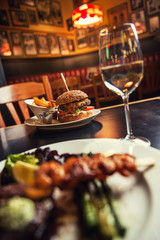 american hamburger with glass of beer of wine in american restaurant, product photography for restaurant in american style