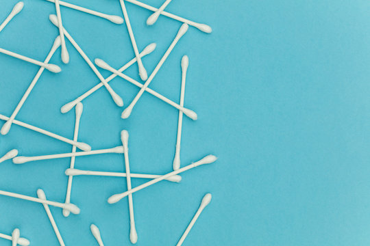 Cotton buds on a blue background. Sanitary qtip hygenic accessory. Plastic waste