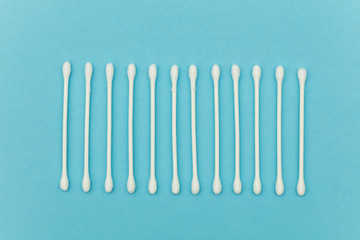 Cotton buds on a blue background. Sanitary qtip hygenic accessory. Plastic waste