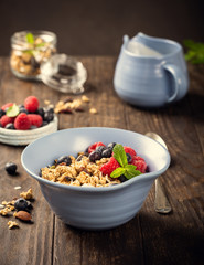 Homemade oatmeal granola or muesli with yogurt and fresh berries for healthy morning breakfast, selective focus. Healthy food background.