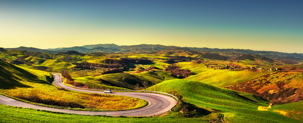Tuscany landscape, road and green field. Volterra Italy