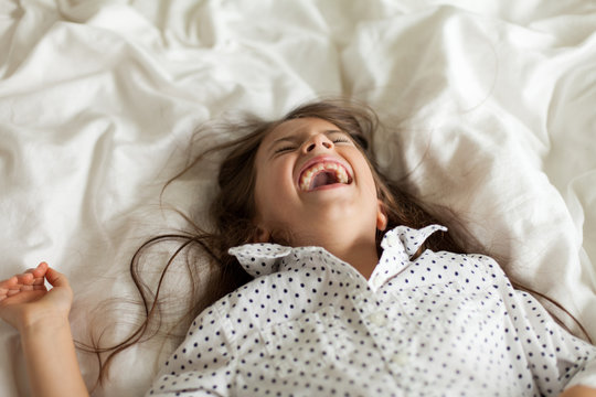 Child with a wide-mouth laugh