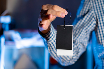 hand holding a blank price tag with copy space f