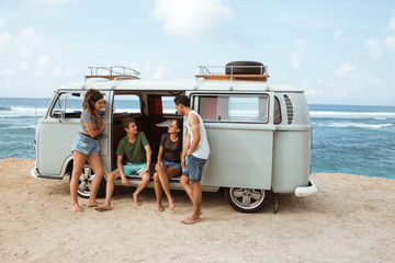 Portrait of friends standing together in beach