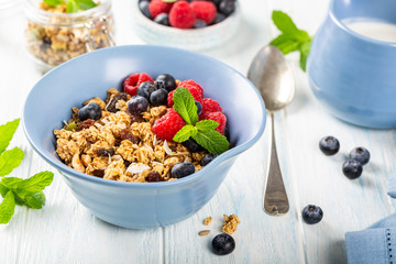 Homemade oatmeal granola or muesli with yogurt and fresh berries for healthy morning breakfast, selective focus. Healthy food background.