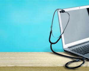 Laptop diagnosis with  stethoscope  on background