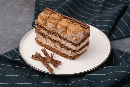 Piece Of Chocolate Cake With Whipped Cream On Stone Table With Dark Blue Napkin