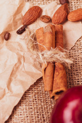 Homemade chocolate for cafes and bars. Cinnamon closeup against the background of a cup of tea. Tea with nuts and a bar of chocolate