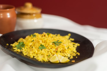 Traditional western Indian breakfast using rice flakes (flattened rice) called Aloo Pohe