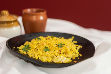 Traditional western Indian breakfast using rice flakes (flattened rice) called Aloo Pohe