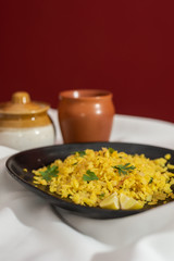 Traditional western Indian breakfast using rice flakes (flattened rice) called Aloo Pohe