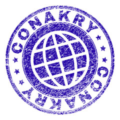 CONAKRY stamp print with grunge texture. Blue vector rubber seal print of CONAKRY label with unclean texture. Seal has words placed by circle and globe symbol.