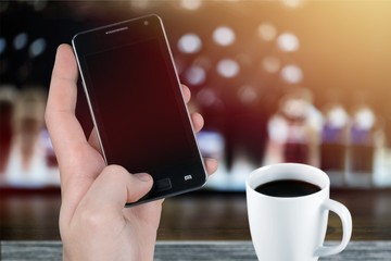Young business man with phone and coffee
