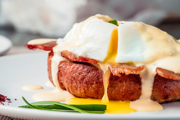 Breakfast is Eggs Benedict - toasted English muffins, bacon, ham, poached eggs, herbs and delicious buttery hollandaise sauce.