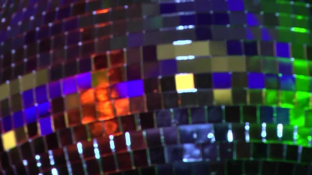 disco mirror ball, colored mirror ball, Rotating mirror disco ball, funky black mirror ball spinning with patterns of light, clubs and parties, closeup of mirror ball