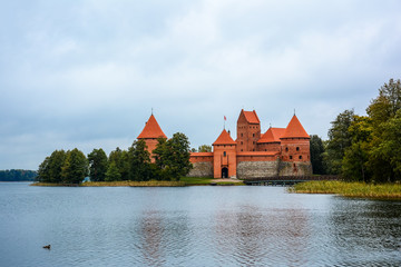 Naklejka na ściany i meble Ancient castle on island in middle of lake. Trakai Island Castle historical landmark, Lithuania.