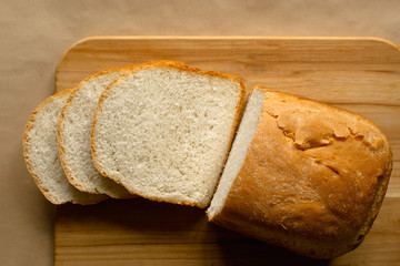 Sliced bread loaf on cutting board. Top down view.