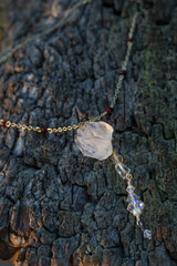 Antique chain natural crystal quartz pendant necklace on wooden background