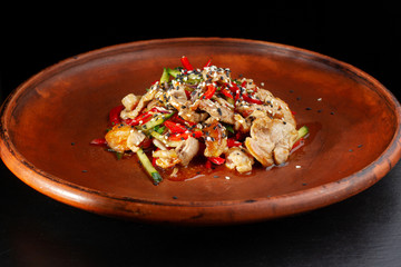 Meat with Vegetables and Piquant Sauce. In the frame of the plate entirely.