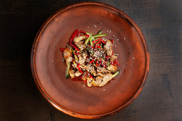 Meat with Vegetables and Piquant Sauce. In the frame of the plate entirely.