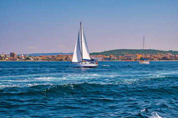 Alghero, Sardinia, Italy - Panoramic view of the Gulf of Alghero with sailboats and the historic...