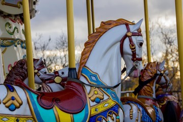 Old horse at a carousel for kids in vintage style. Selective focus.