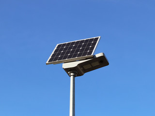 Obraz premium Solar panel on a blue sky. Photovoltaic cells. Method of obtaining alternative energy. Ecologically clean electricity. High technology of electronics. Energy independence.