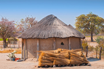 Typical thatched roof African round hut in Botswana.